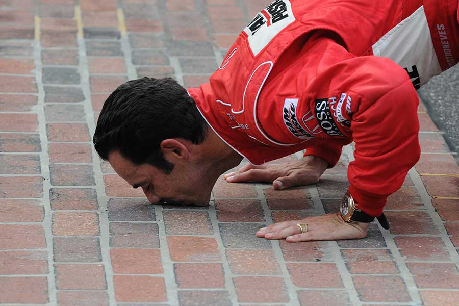 2009: Helio Castroneves kisses the yard of bricks that form the finish line after winning his third Indy 500 race